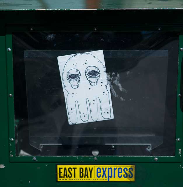 Sidewalk newsbox grafitti, downtown Oakland.