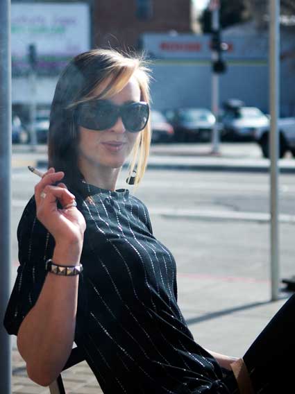 A young woman this afternoon at a sidewalk table.