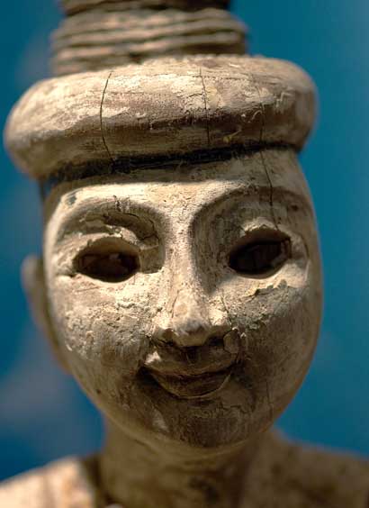 A carved figure in a display case in Oakland