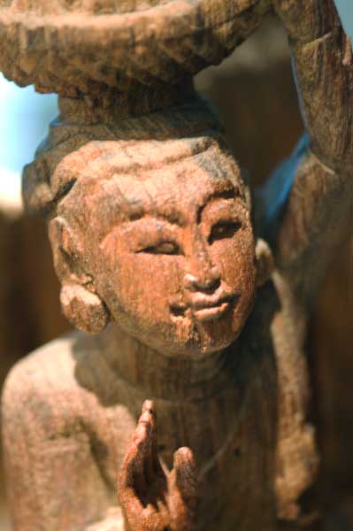 A carved figure in a display case in Oakland