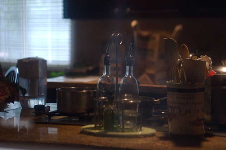 Kitchen reflected in an oven door.