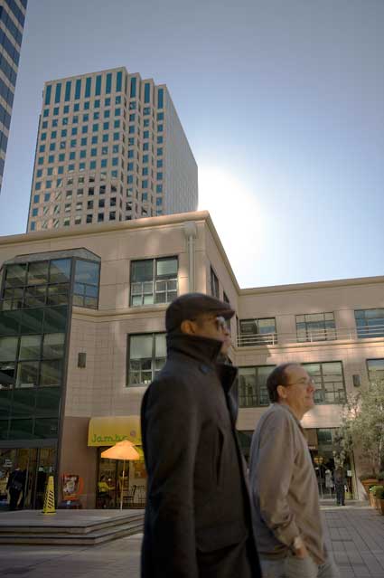 Oakland City Center with the sun behind the APL building.