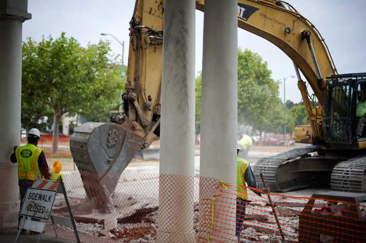 Digging up the streets and sidewalk beside Lake Merrit in Oakland.