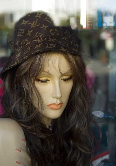 Beauty supply shop window on Grand Street in Oakland