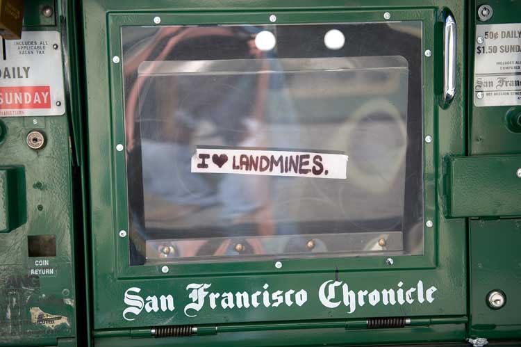 A sidewalk news box in the Lake Merritt area of Oakland.